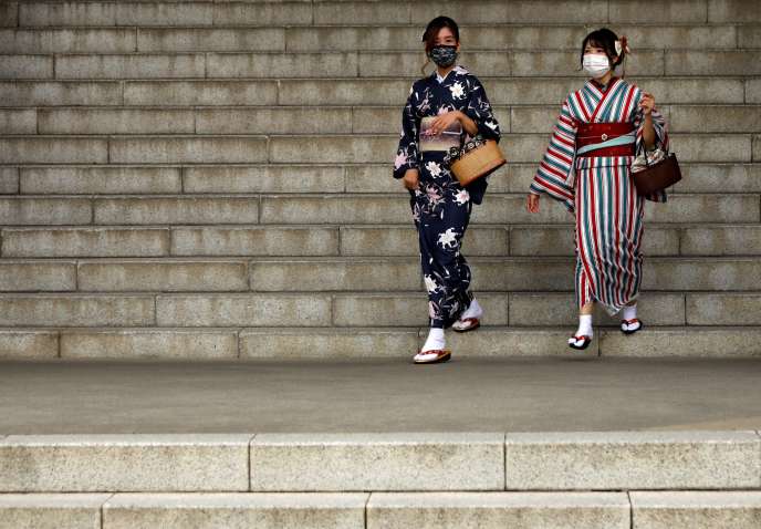 Deux femmes portent le masque devant le temple du quartier d’Asakusa, à Tokyo, le 13 octobre.